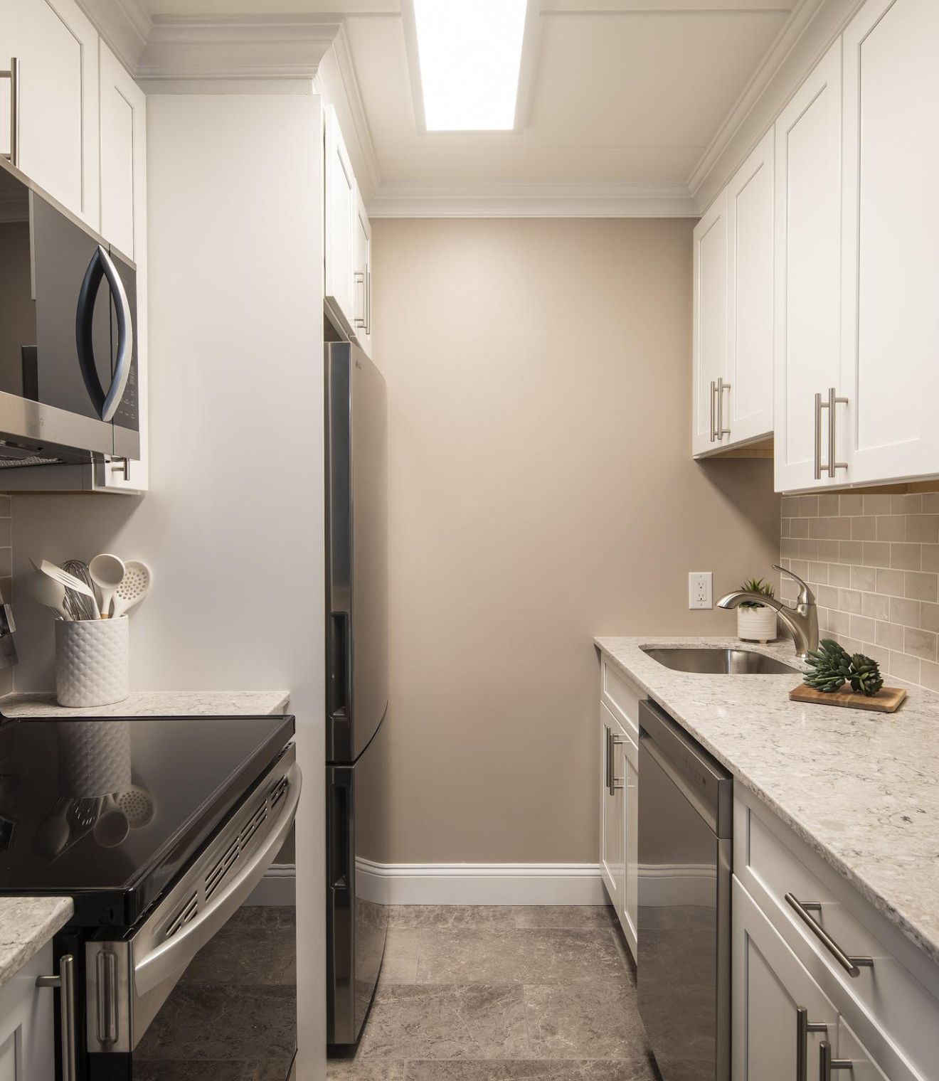 Uptown 550 Midrise spacious kitchen with custom cabinetry and stainless steel appliances