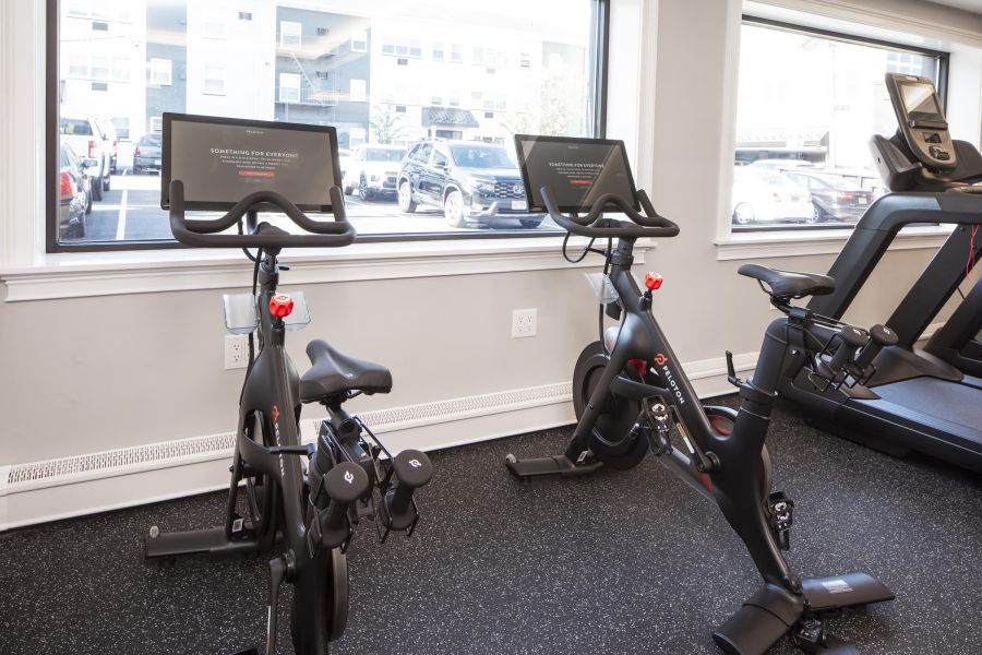 Hickory Manor Apartment building with black and white exterior, fire escapes, and garages on the ground floor.