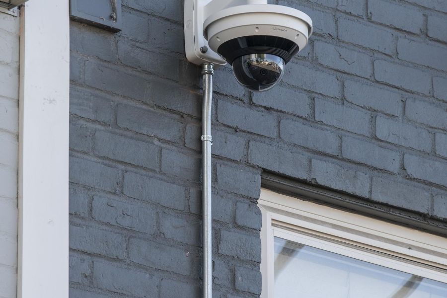 Hickory Manor A modern apartment building with landscaped gardens and a wooden entrance canopy under a partly cloudy sky.