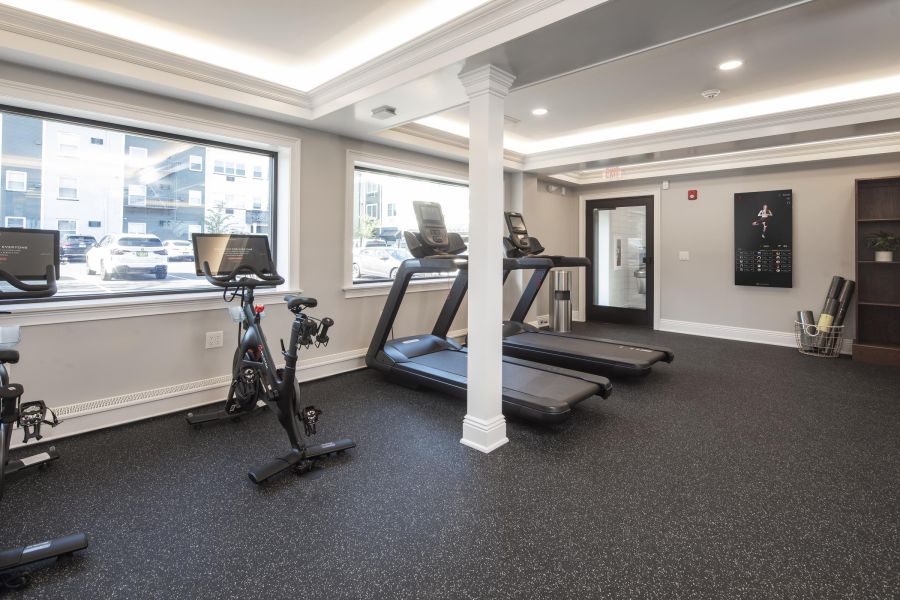 Hickory Manor Apartment building with black and white exterior, fire escapes, and garages on the ground floor.