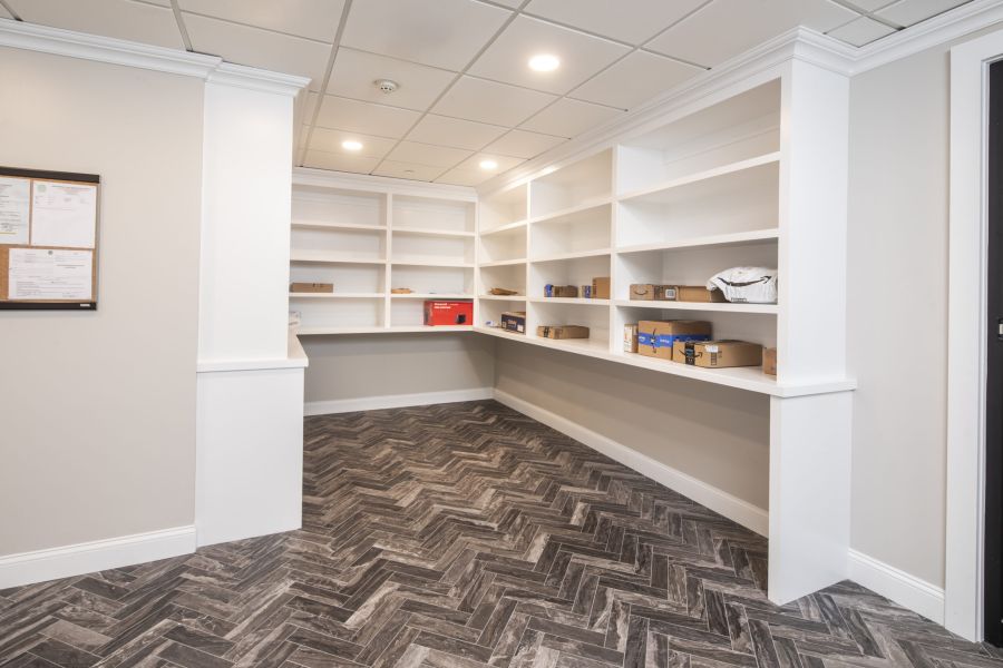 Legion Manor Checkers game in progress on a wooden table outdoors, with red and black pieces on a fabric board.