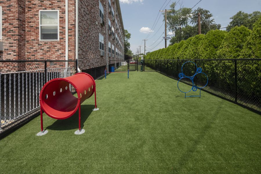 Legion Manor Small package room with shelves, a bulletin board, and packages on the floor and shelf.