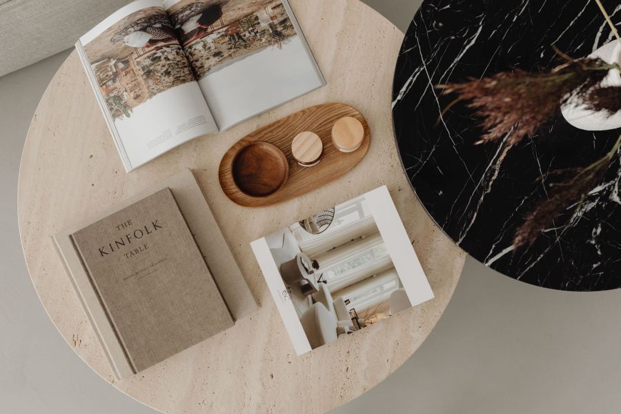 Legion Manor Stone and marble round tables with books and home decor