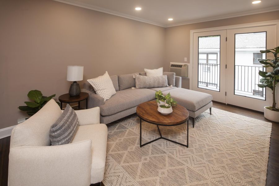 Linden Apartments Modern Spacious Living Room with mid-century furnishings and floor-to-ceiling windows