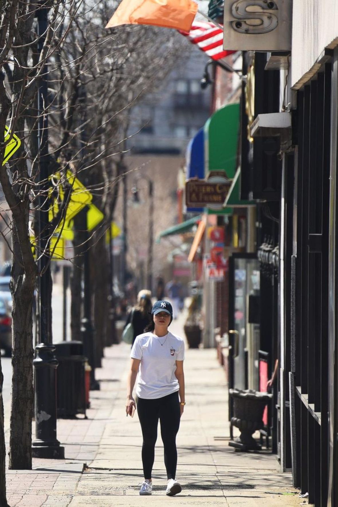 North Washington Square at Hickory A vintage clock stands in a plaza with blooming trees and a domed building in the background.