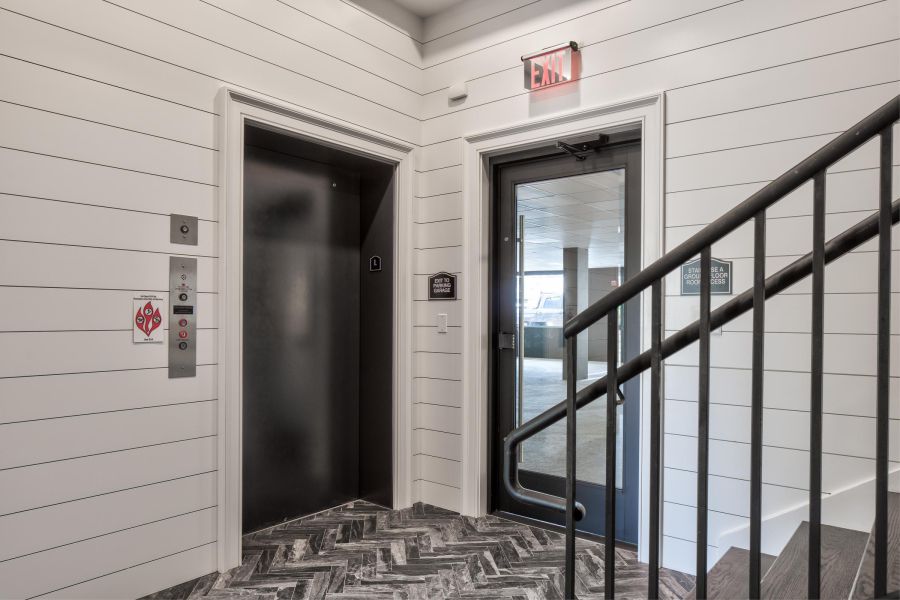 North Washington Square at Hickory Small package room with shelves, a bulletin board, and packages on the floor and shelf.
