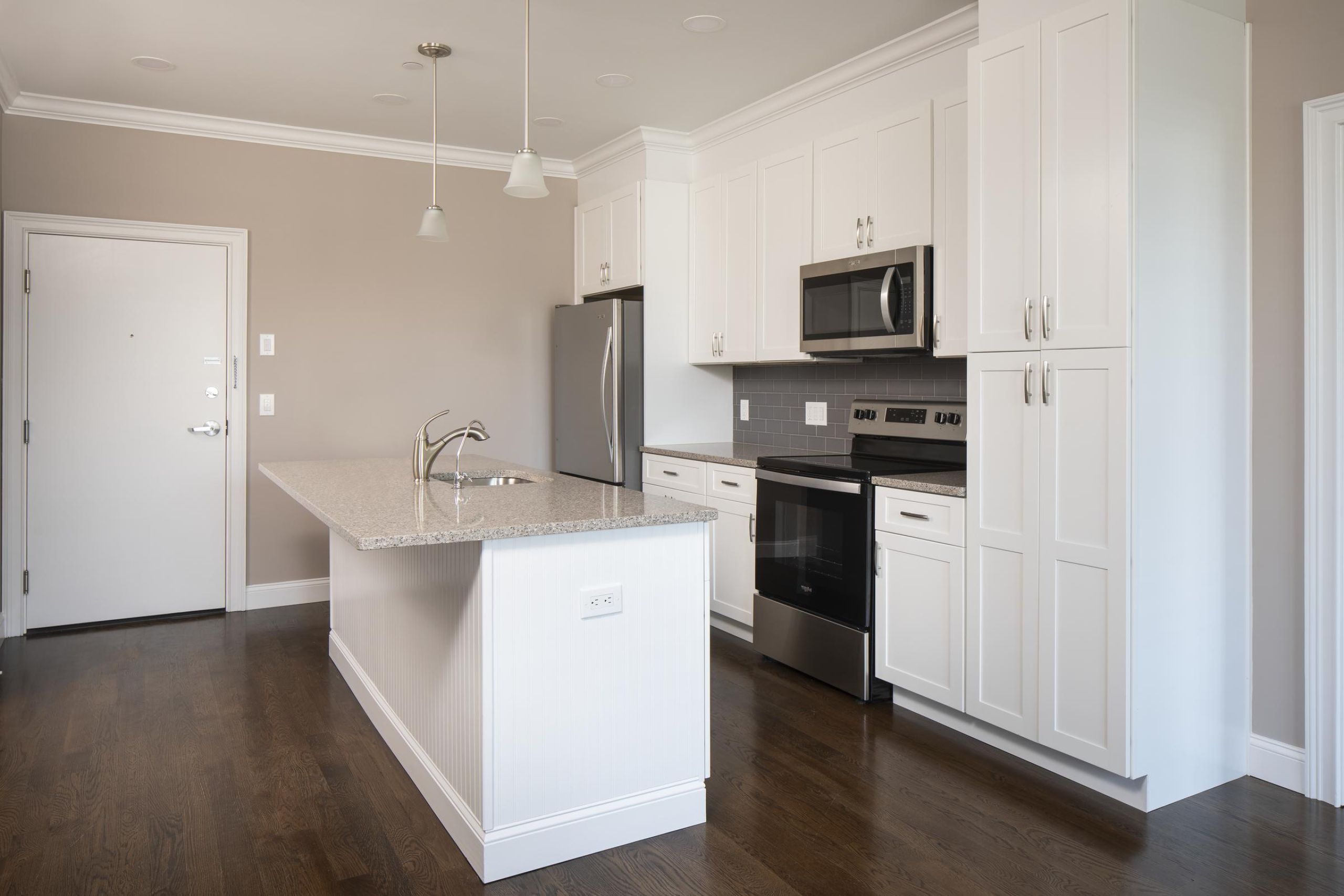 North Washington Square at HickoryPatio with wooden pergola, outdoor seating, chairs, and plants, overlooking a green lawn with flags.