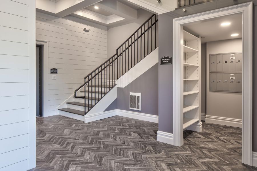 North Washington Square at Hickory Small package room with shelves, a bulletin board, and packages on the floor and shelf.