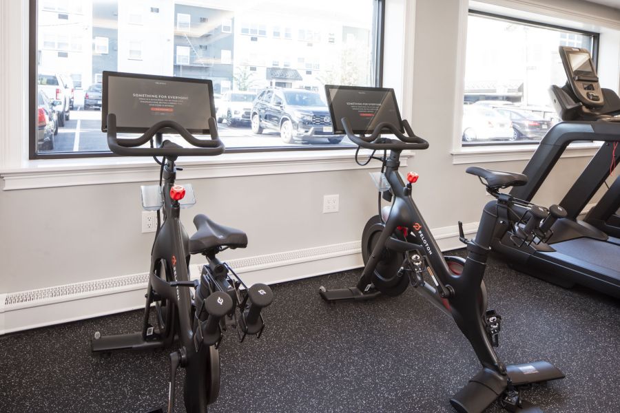 North Washington Square at Hickory Apartment building with black and white exterior, fire escapes, and garages on the ground floor.