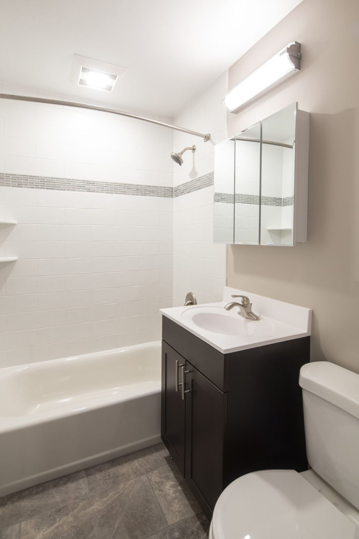 Regency Manormodern mid-century furnished bedroom with bed, side table, and round mirror