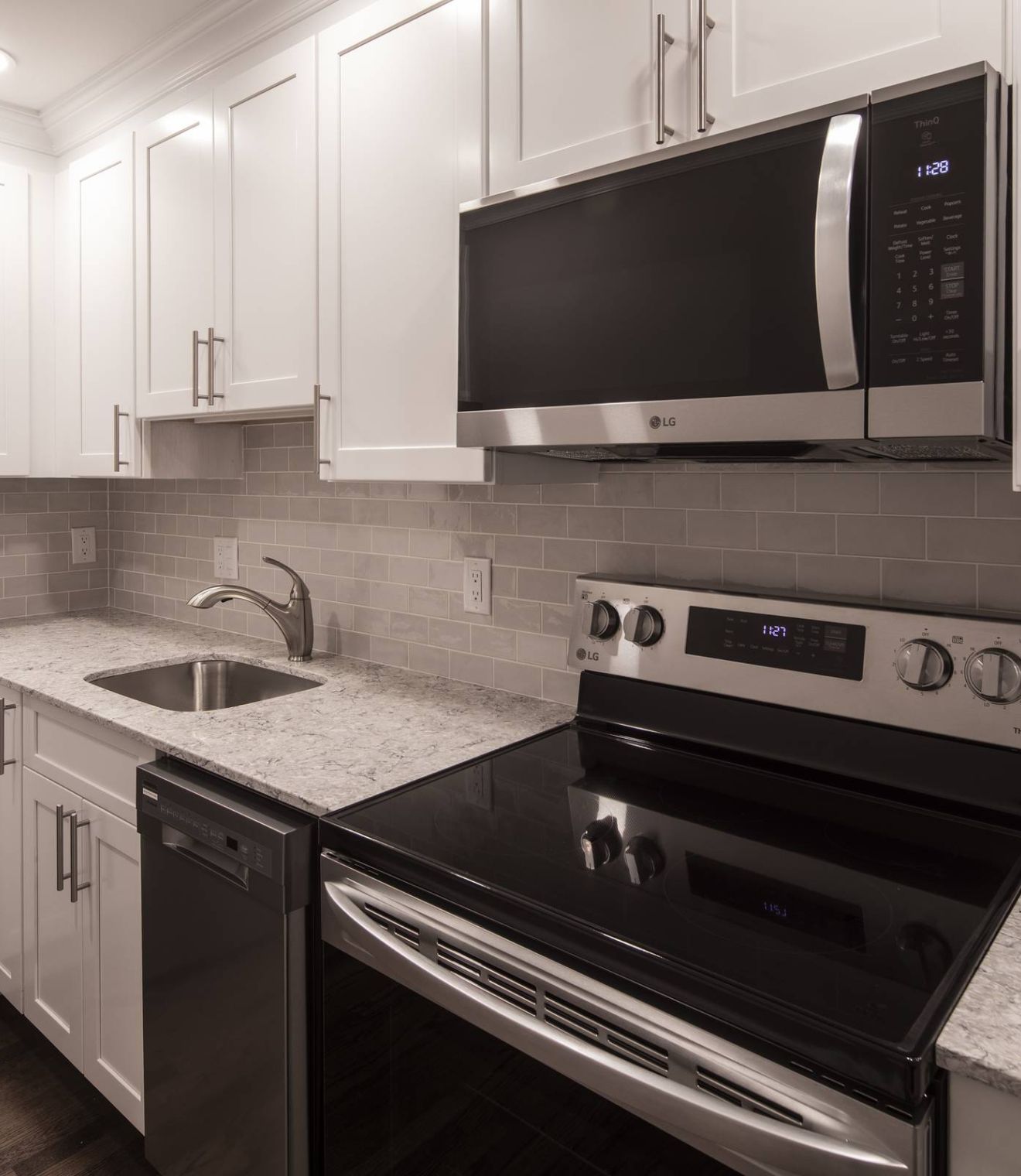 Uptown 550 Midrise spacious kitchen with custom cabinetry and stainless steel appliances