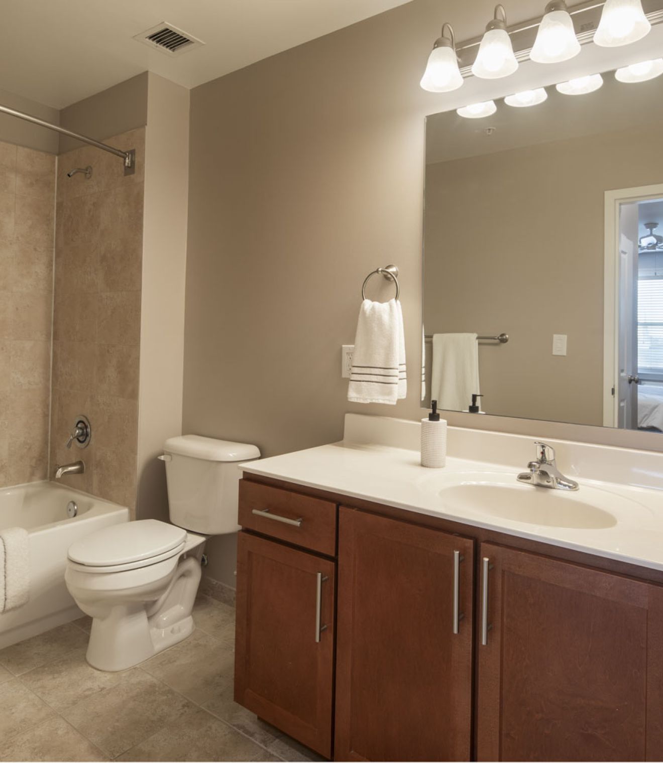 Uptown 550 Midrise spacious kitchen with custom cabinetry and stainless steel appliances