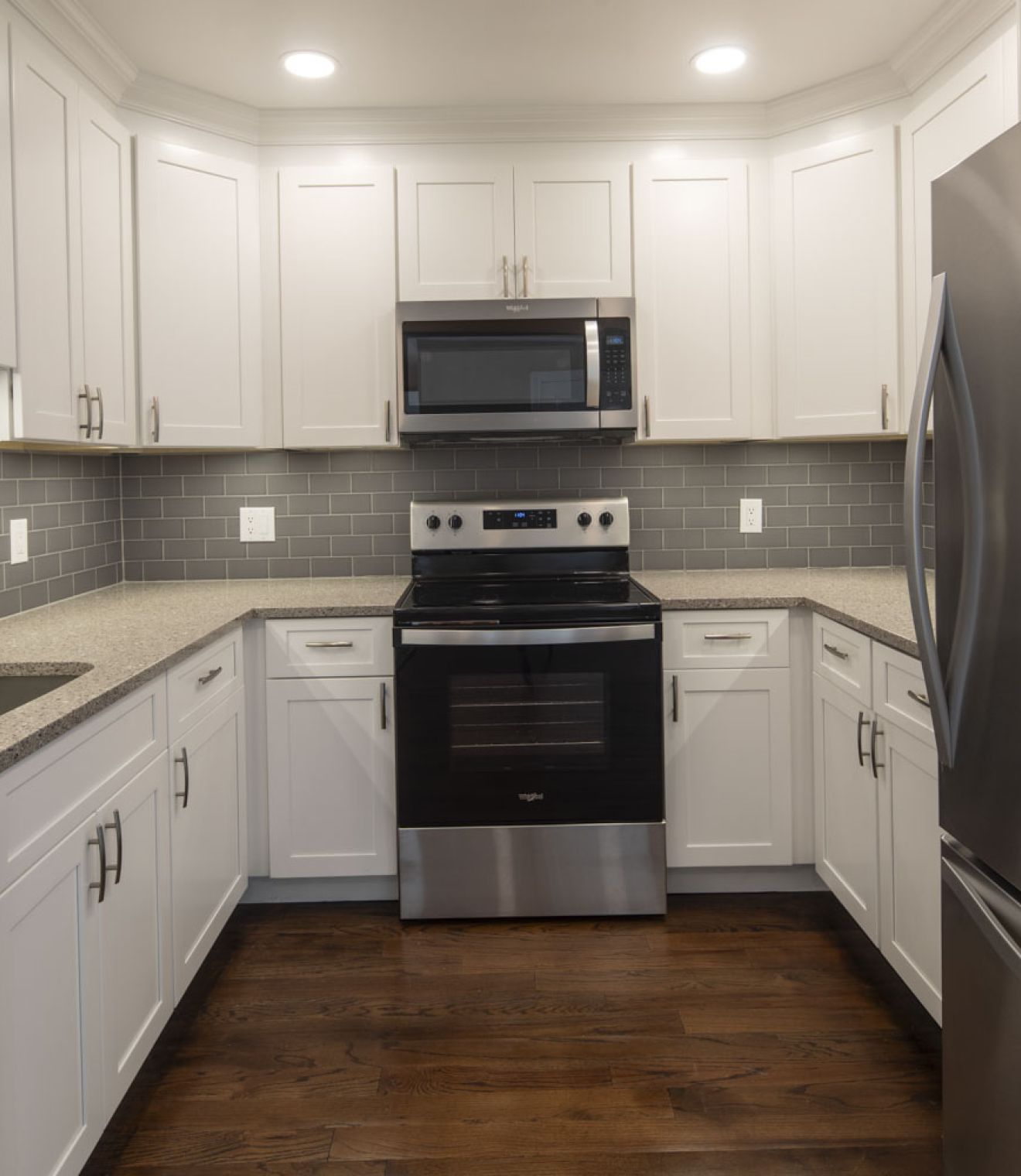 Uptown 550 Midrise spacious kitchen with custom cabinetry and stainless steel appliances