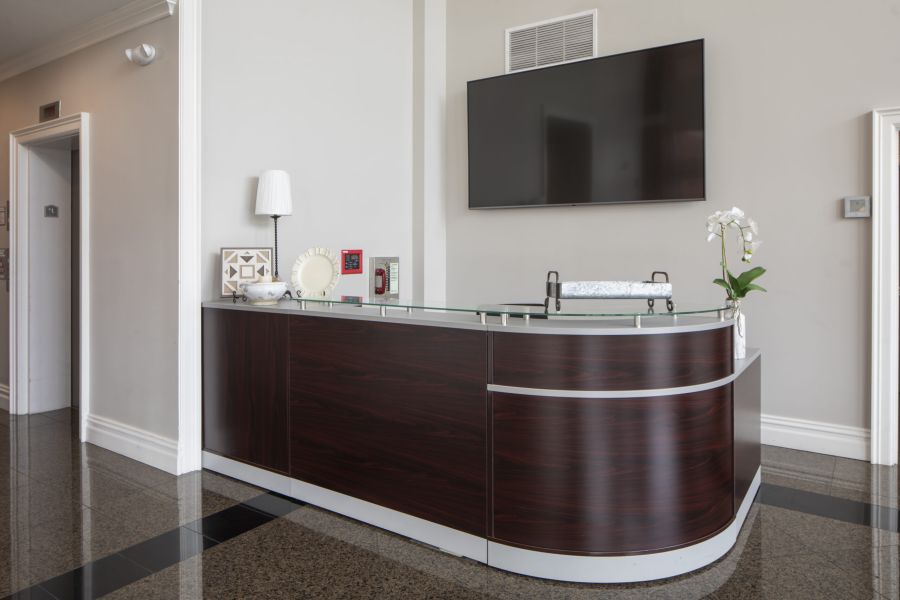 The Atrium Small package room with shelves, a bulletin board, and packages on the floor and shelf.