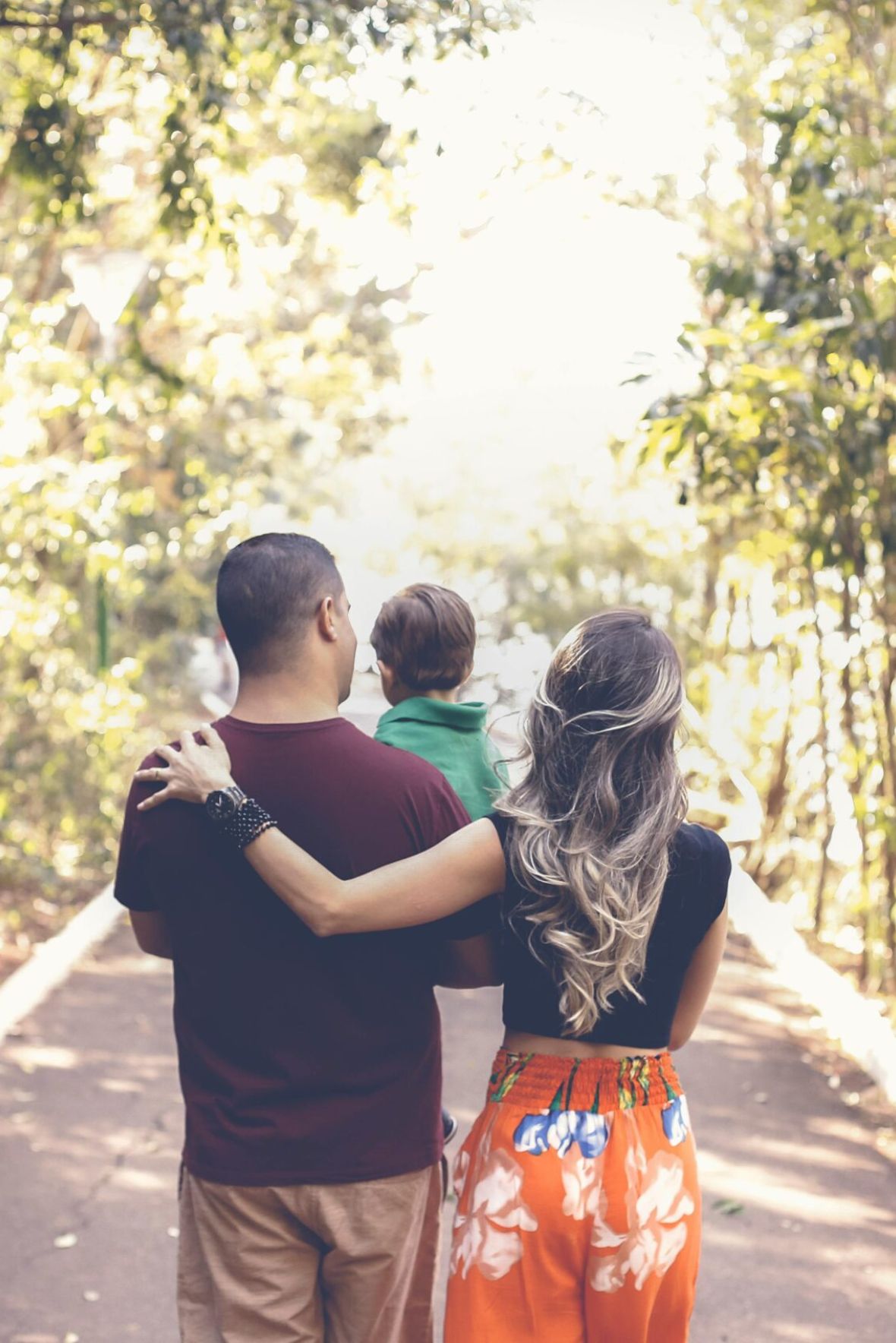 The Atriummodern mid-century furnished bedroom with bed, side table, and round mirror