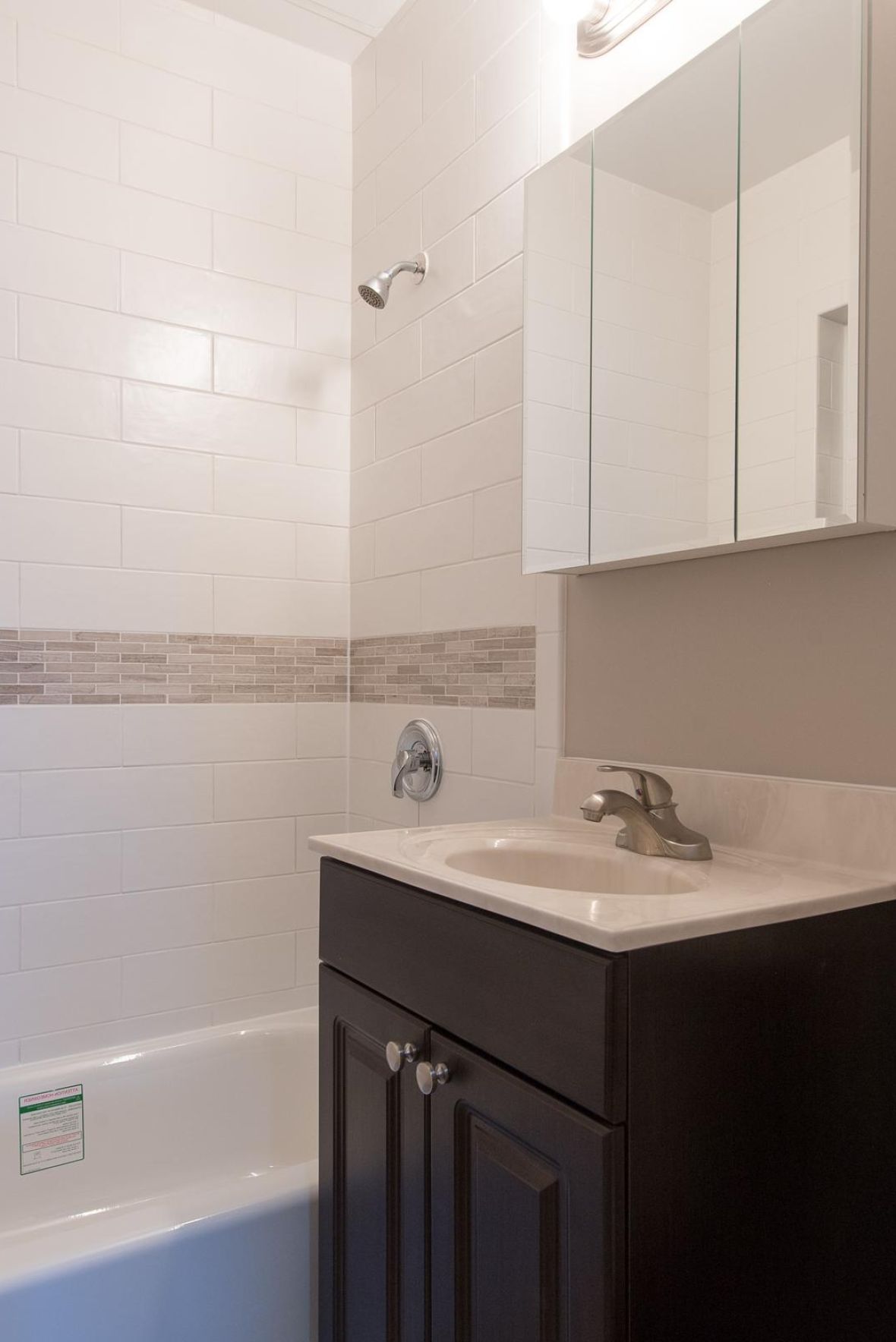 The Cornerstonemodern mid-century furnished bedroom with bed, side table, and round mirror
