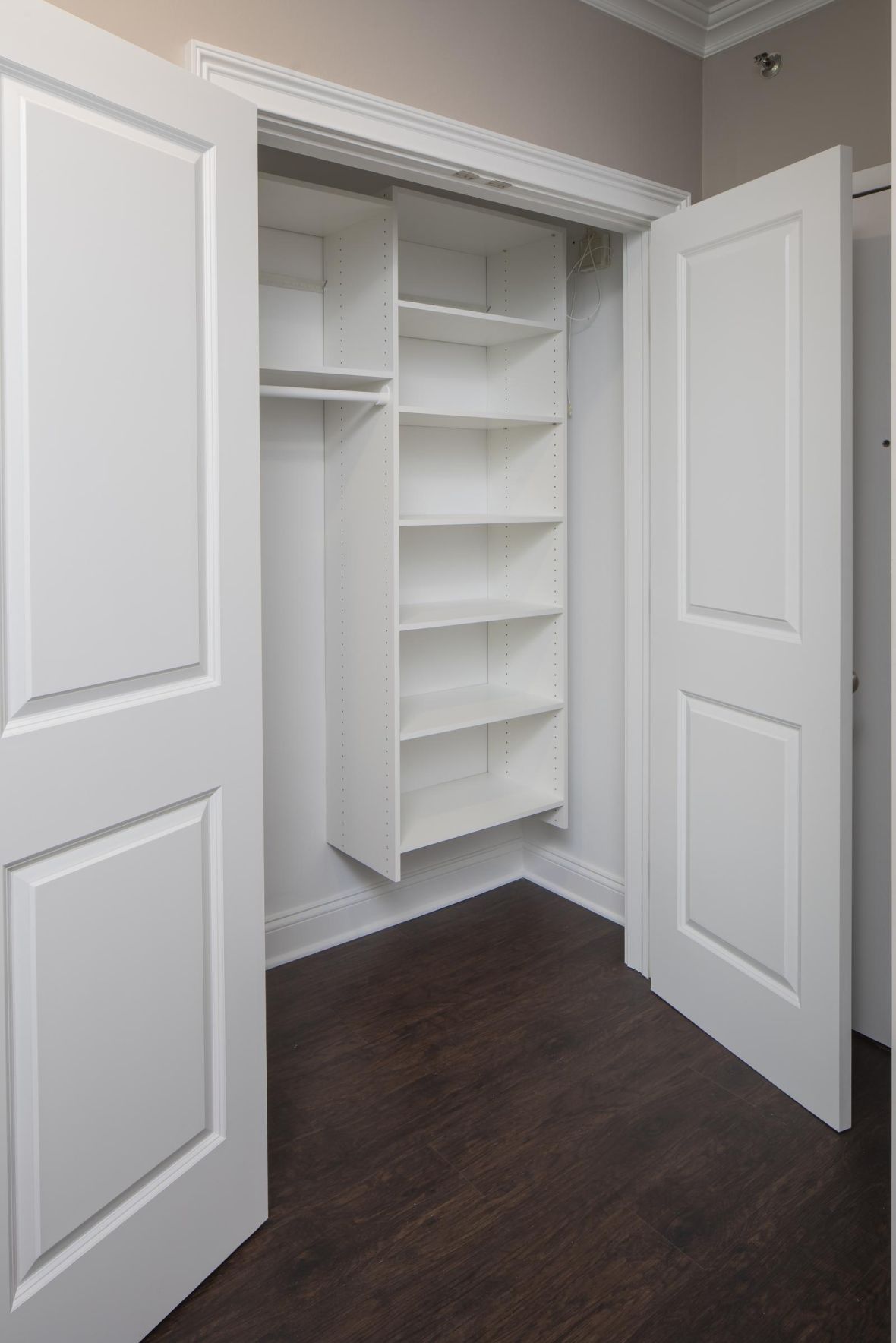The Cornerstone Modern Minimal Apartment Kitchen with butcher block counters and industrial light fixtures