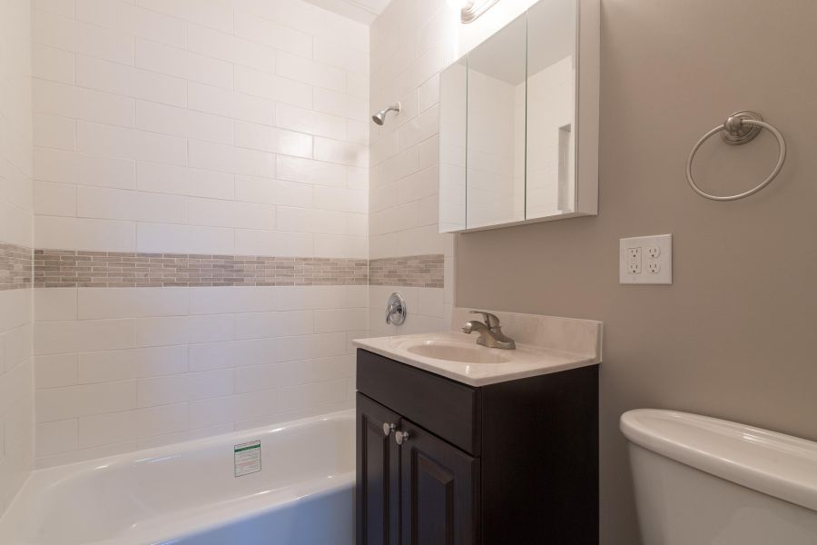 The Cornerstone Modern Spacious Living Room with mid-century furnishings and floor-to-ceiling windows