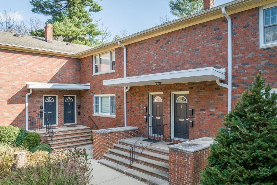 The East Hill Small package room with shelves, a bulletin board, and packages on the floor and shelf.