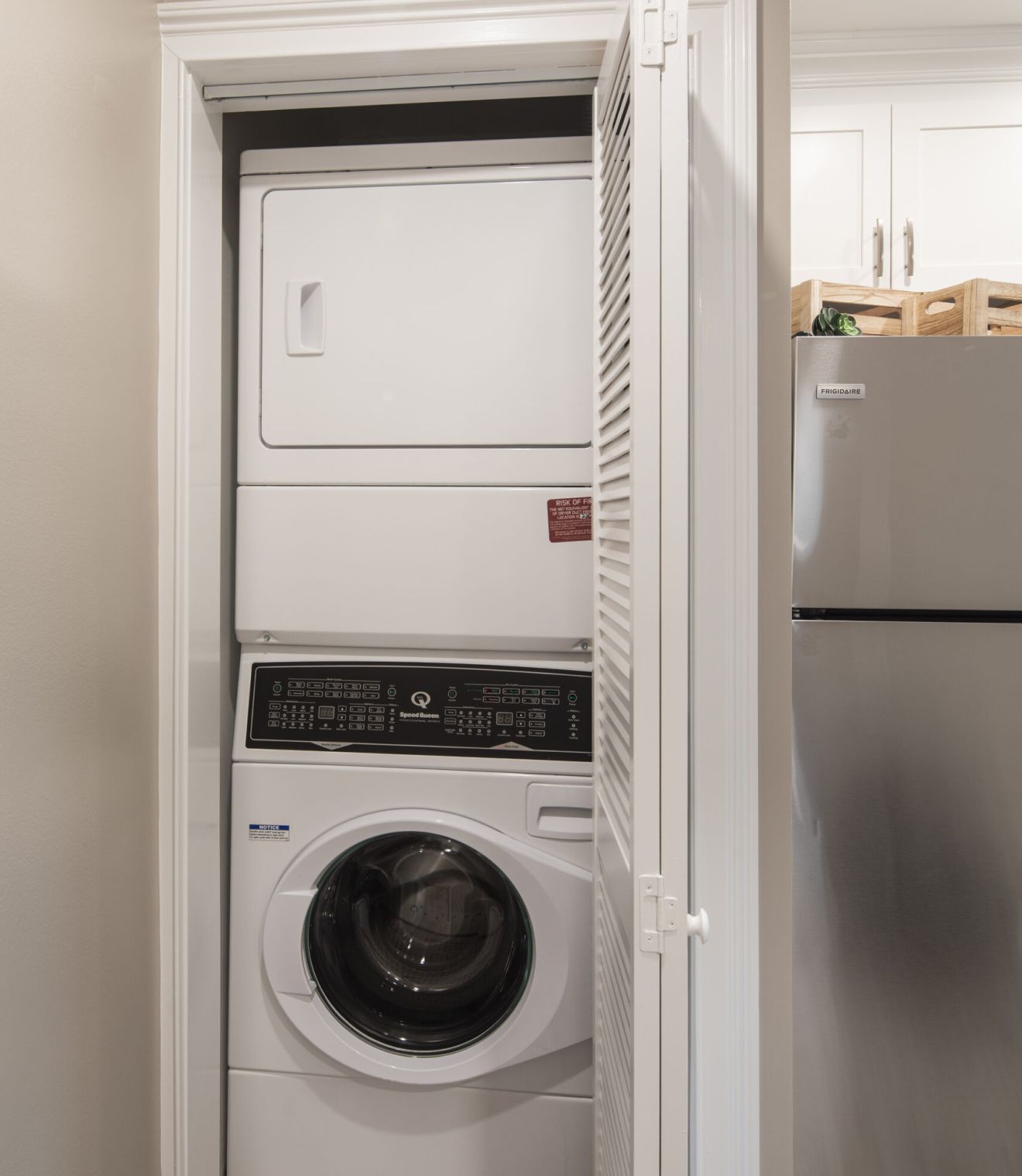 Uptown 550 Midrise spacious kitchen with custom cabinetry and stainless steel appliances