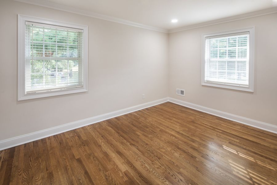 The East Hill Modern Spacious Living Room with mid-century furnishings and floor-to-ceiling windows