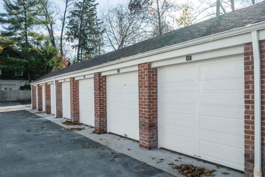 The East Hill Small package room with shelves, a bulletin board, and packages on the floor and shelf.