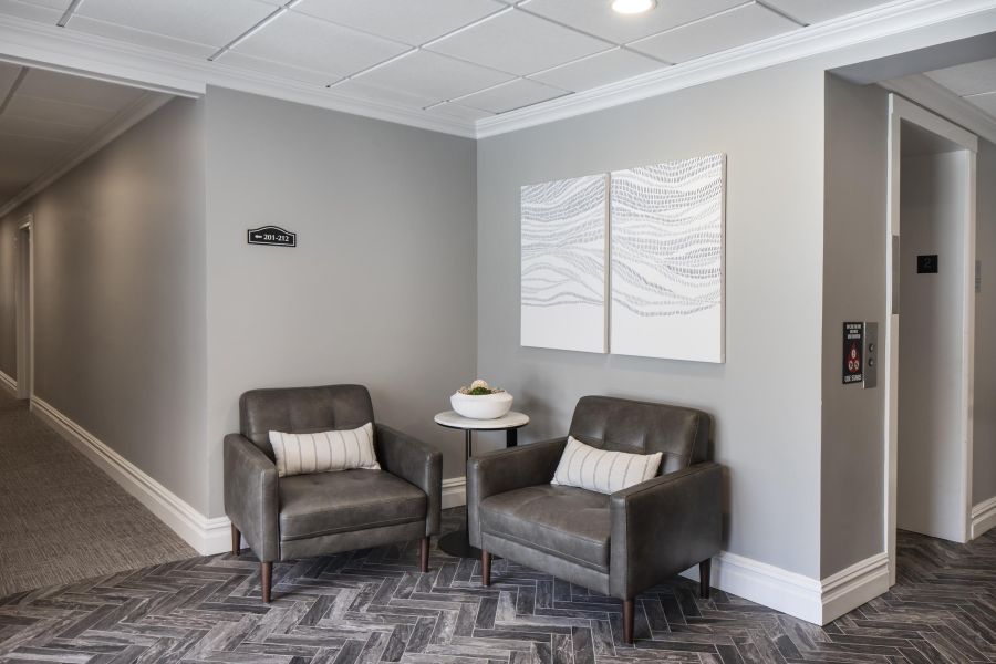 The Parkview @ Polifly Small package room with shelves, a bulletin board, and packages on the floor and shelf.