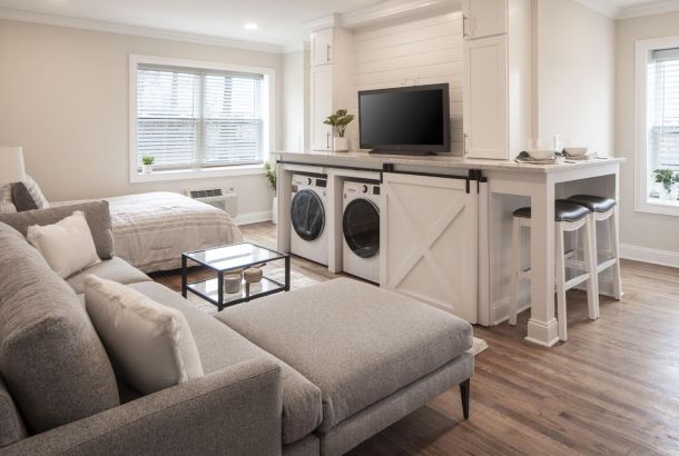 A living room with a tv and washing machines.
