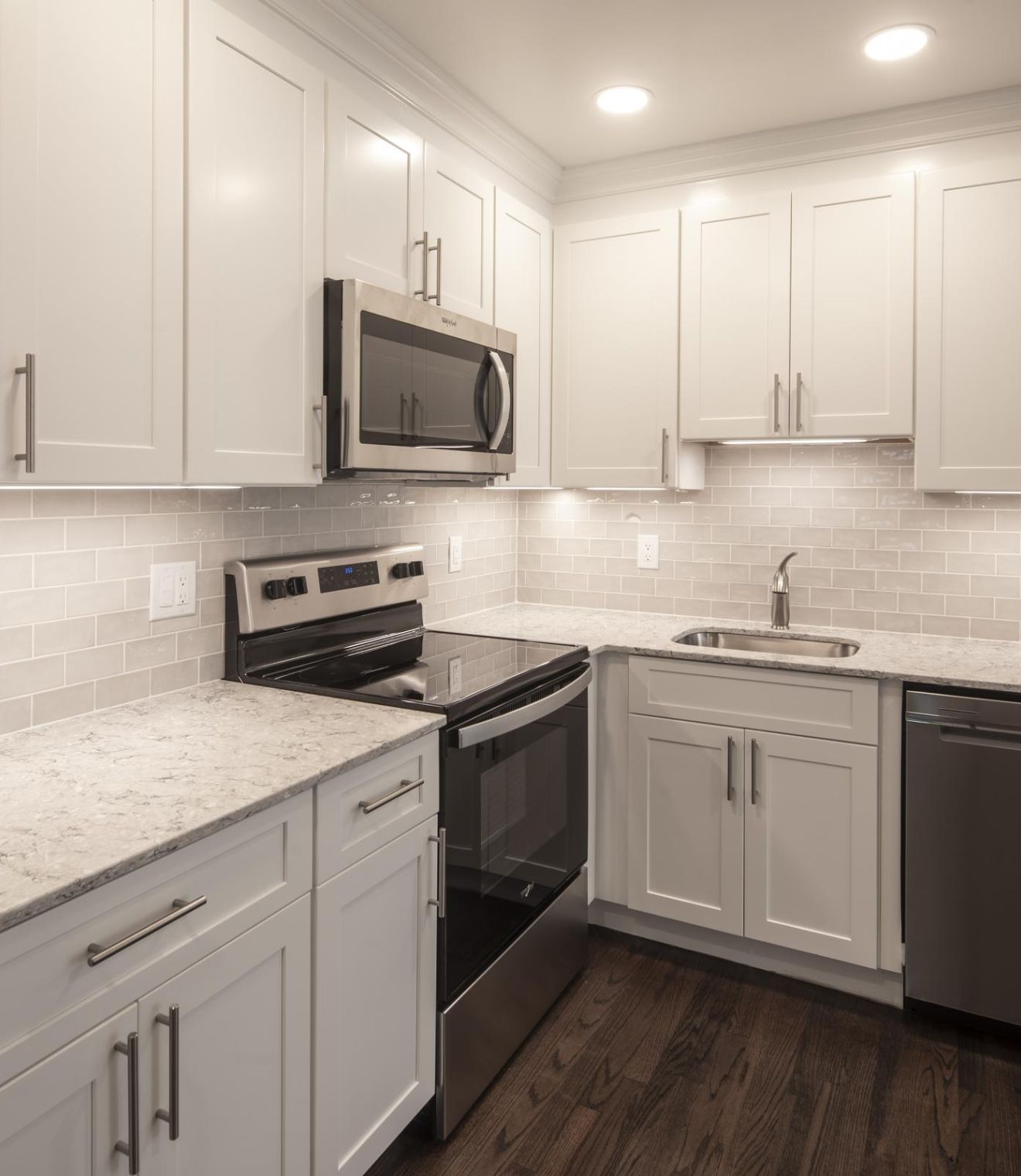 Uptown 550 Midrise spacious kitchen with custom cabinetry and stainless steel appliances