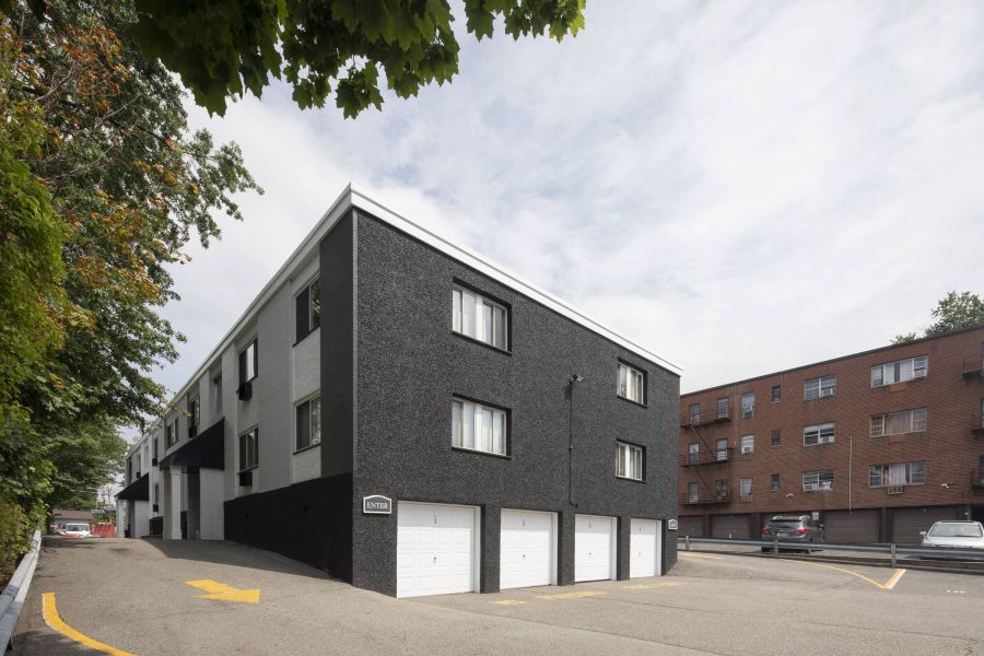 West Church Gardens Checkers game in progress on a wooden table outdoors, with red and black pieces on a fabric board.