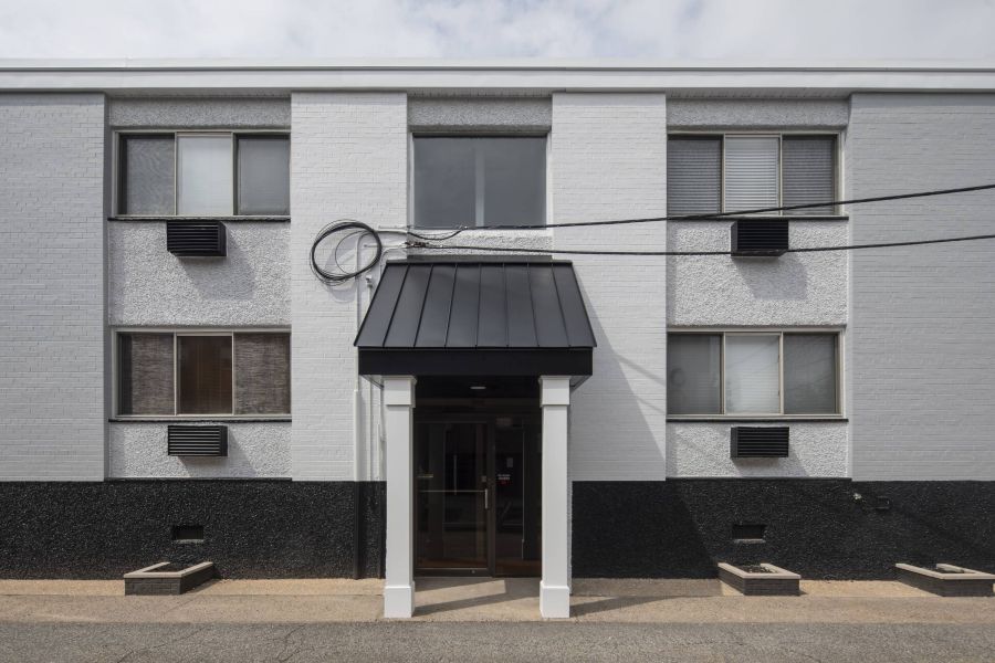West Church Gardens Small package room with shelves, a bulletin board, and packages on the floor and shelf.