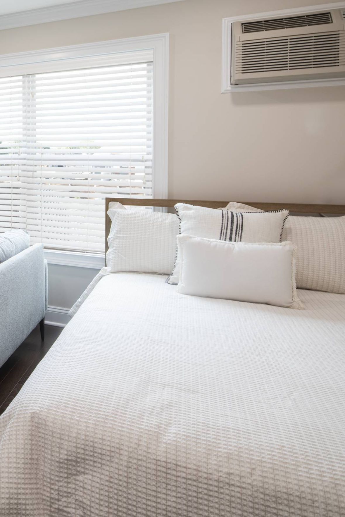 Westwood Manormodern mid-century furnished bedroom with bed, side table, and round mirror