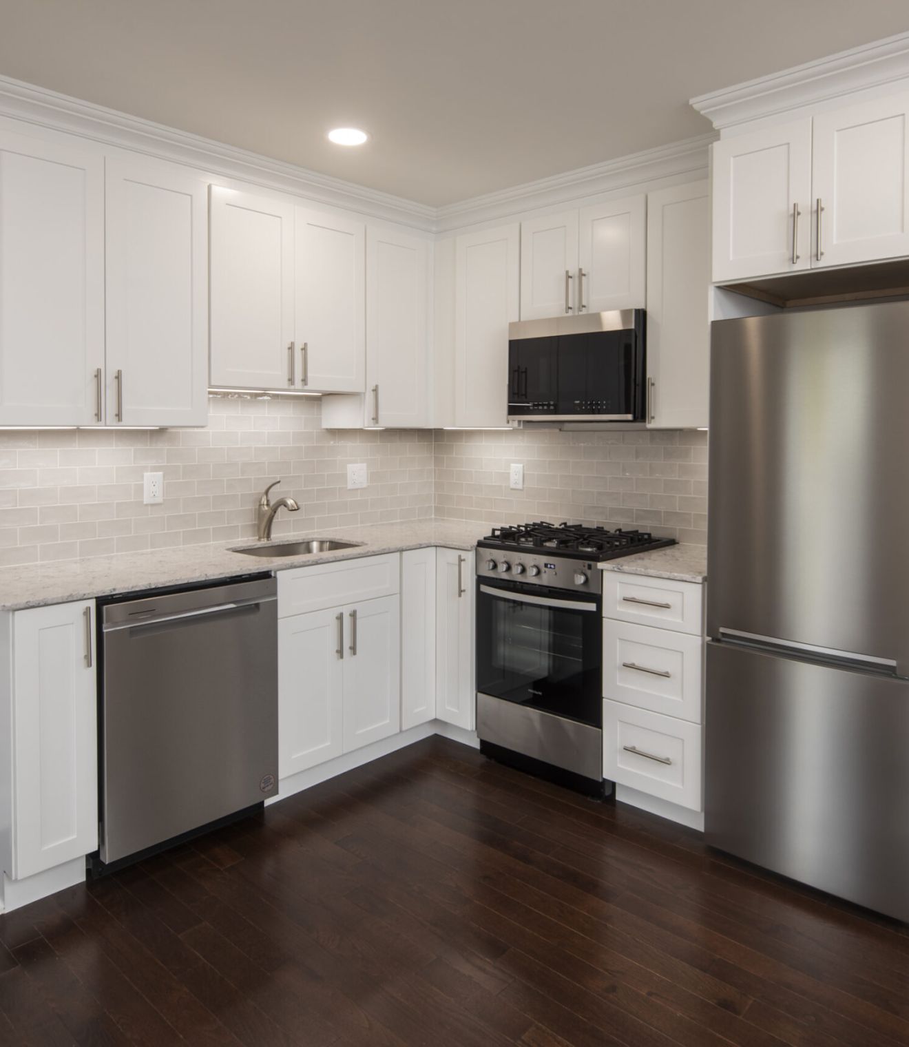 Uptown 550 Midrise spacious kitchen with custom cabinetry and stainless steel appliances
