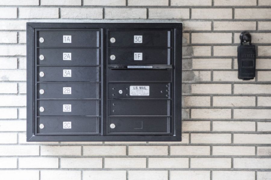 Westwood Manor Two cream chairs and a wooden table with plants and decor against a modern, light wall.