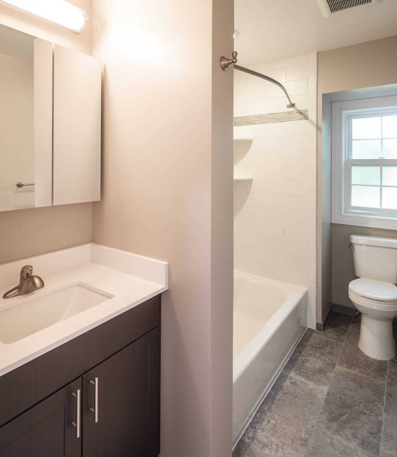 Uptown 550 Midrise spacious kitchen with custom cabinetry and stainless steel appliances