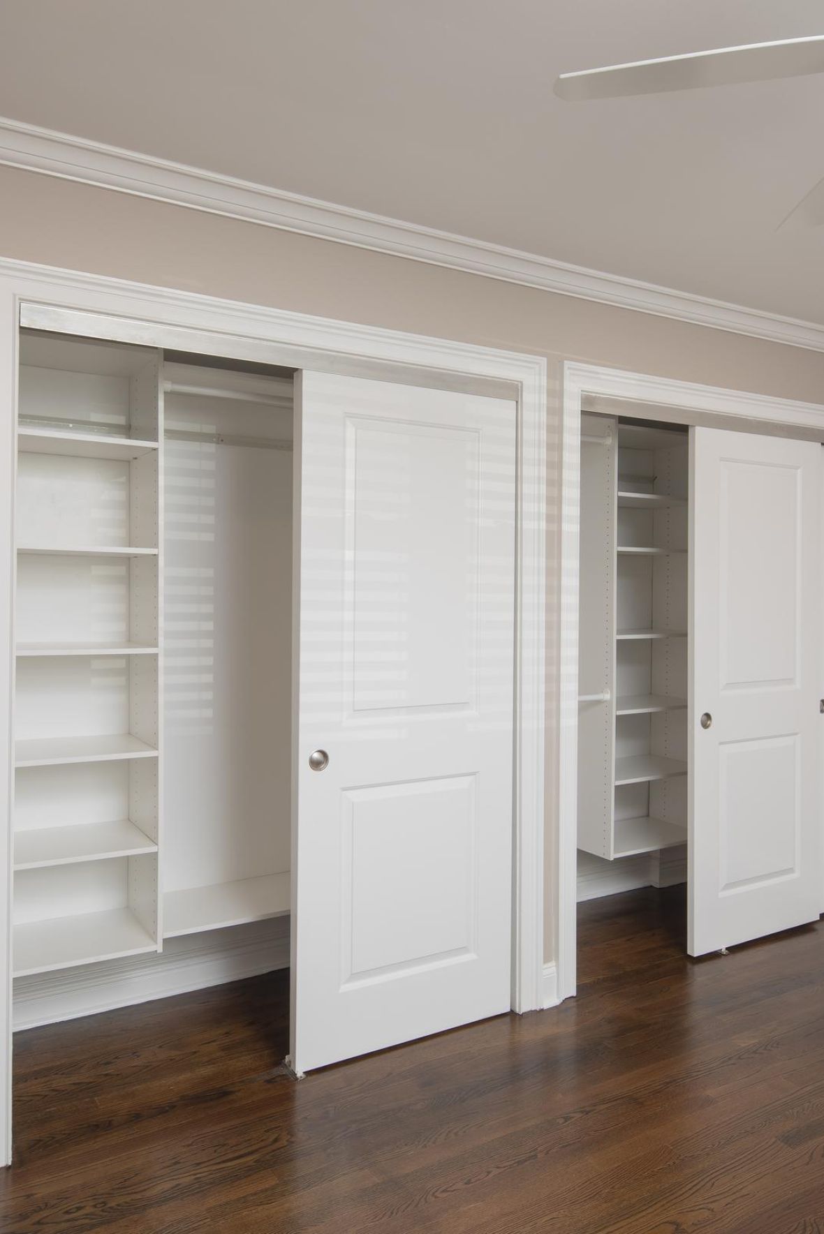 Woodland Hills Manormodern mid-century furnished bedroom with bed, side table, and round mirror