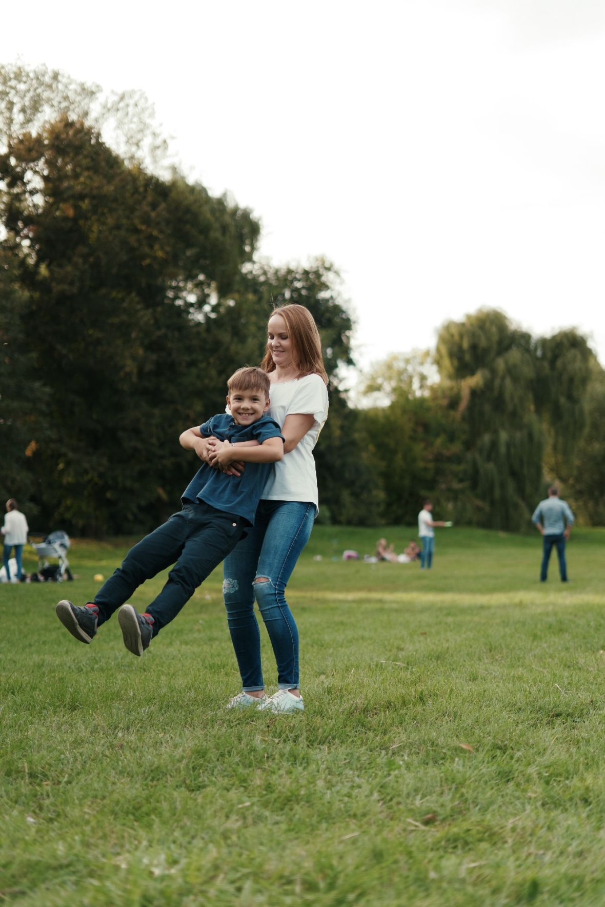 Woodland Hills Manor A vintage clock stands in a plaza with blooming trees and a domed building in the background.